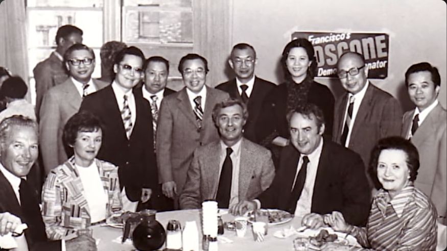 Archival group photograph with a George Moscone campaign sign, shown in AACMA’s documentary