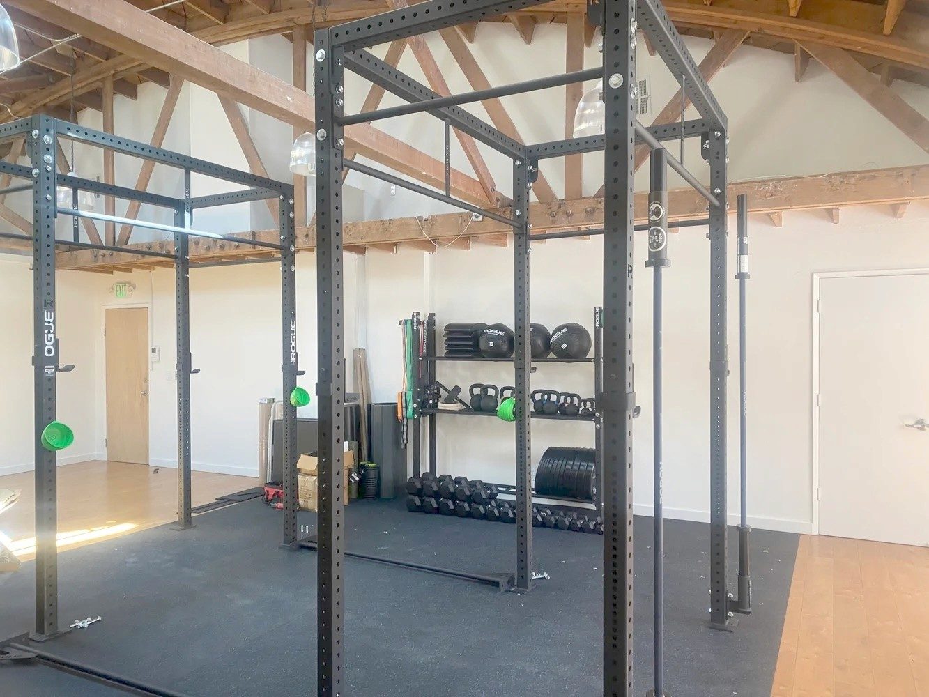 Squat racks and free weights in the clinic's gym area