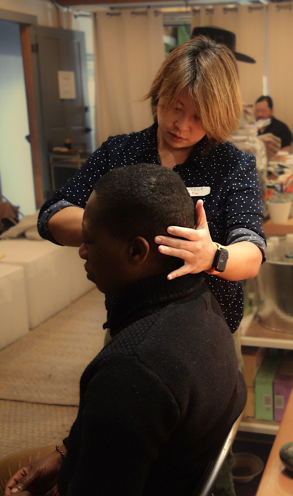 Dr. Deb performing a hands-on neck and head treatment on a seated patient