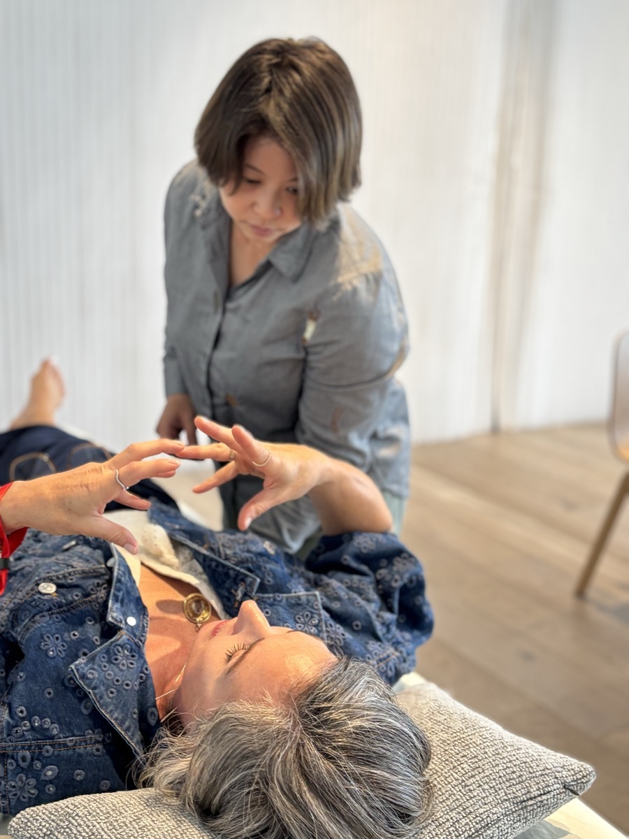 Dr Deb working with a patient’s hands during a treatment session